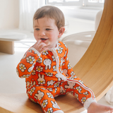 Baby wearing the ZIPSTER x Miffy Daisy Days bamboo babygrow